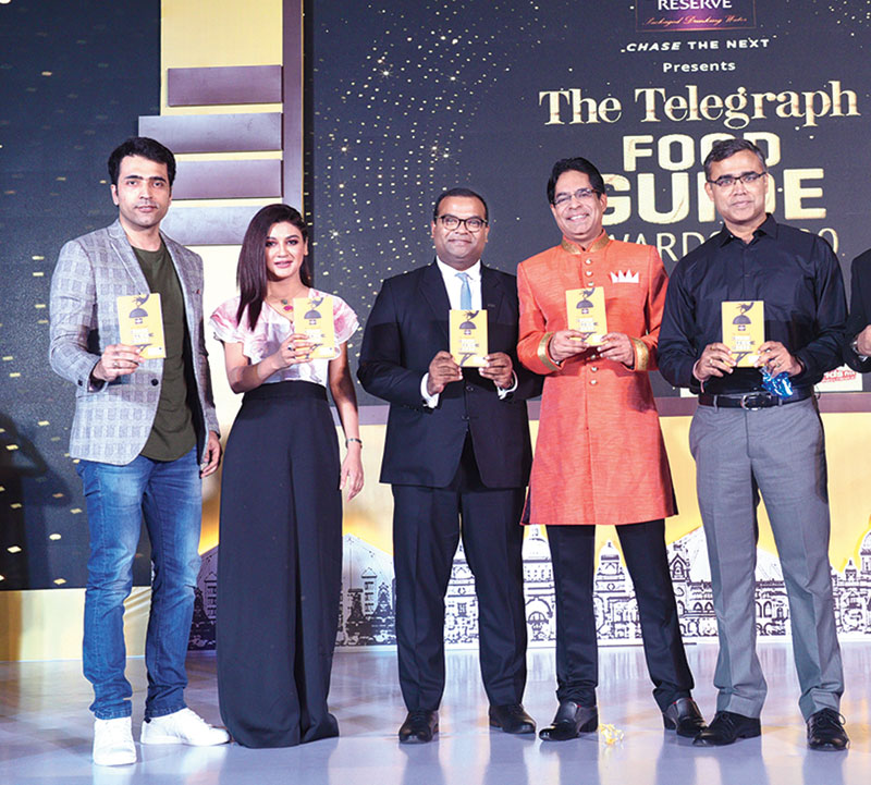 The most awaited moment of the evening was the launch of the Sterling Reserve Presents The Telegraph Food Guide 2020, in association with IIHM and David & Goliath. 
(L-R) Actors Abir Chatterjee and Jaya Ahsan, general manager of Hyatt Regency Kolkata Kumar Shobhan, Suborno Bose of IIHM and Sayan Chakraborty of Allied Blenders and Distillers Pvt Ltd unveiled the book amidst a burst of confetti and applause.