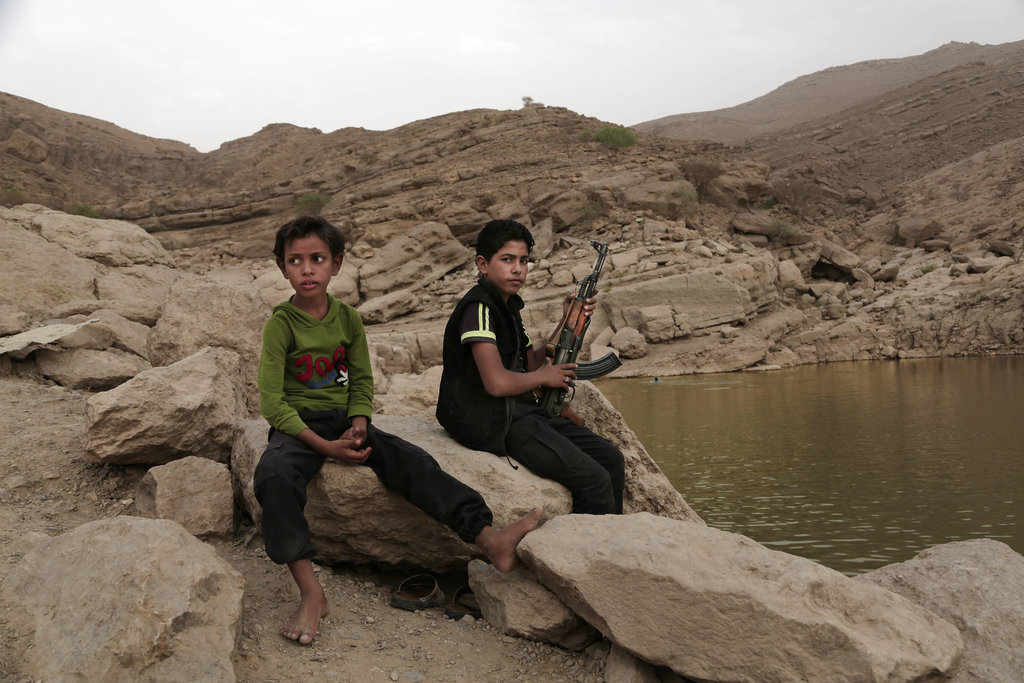A 17-year-old boy holds his weapon in High dam in Marib, Yemen. Experts say child soldiers are “the firewood” in the inferno of Yemen’s civil war, trained to fight, kill and die on the front lines. Though both sides in the war recruit children, the Houthi rebels rely on them the most.
