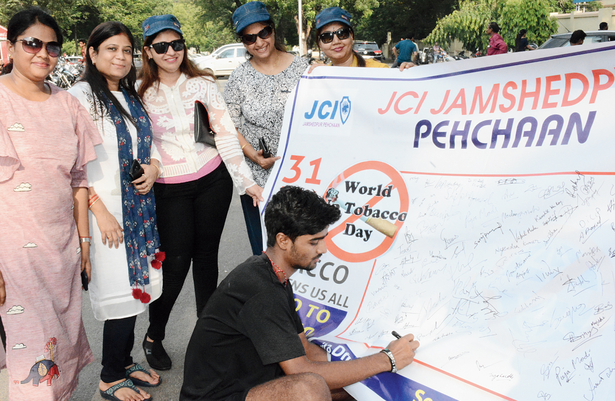 Members of social outfit Junior Chamber International take part in a signature campaign against tobacco consumption near Keenan Stadium in Jamshedpur on Friday