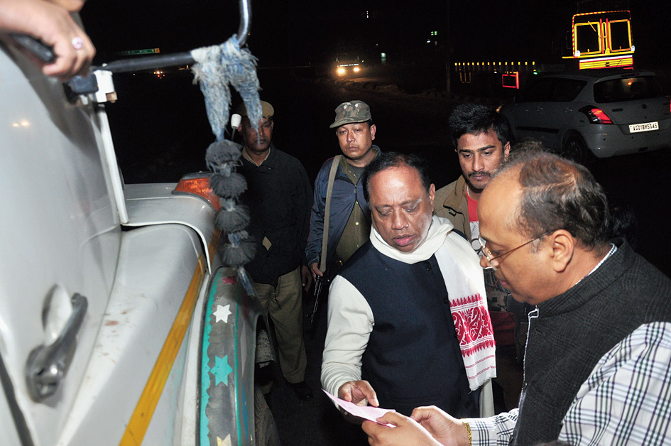 Assam forest minister Parimal Suklabaidya checks papers of a truck loaded with sand near Saraighat bridge in Guwahati on Sunday.