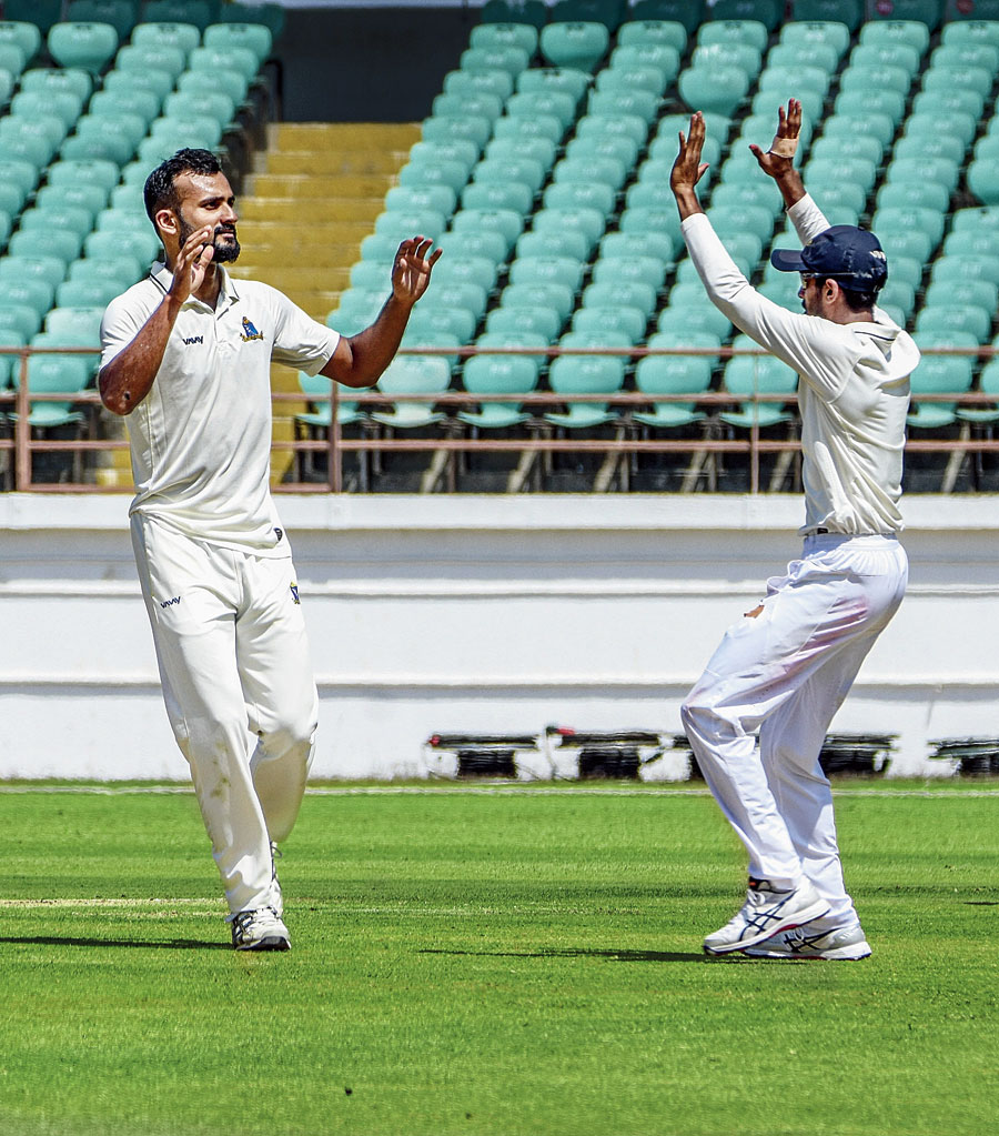 Aakash Deep (left) celebrates taking the wicket of Avi Barot in Rajkot on Monday. 