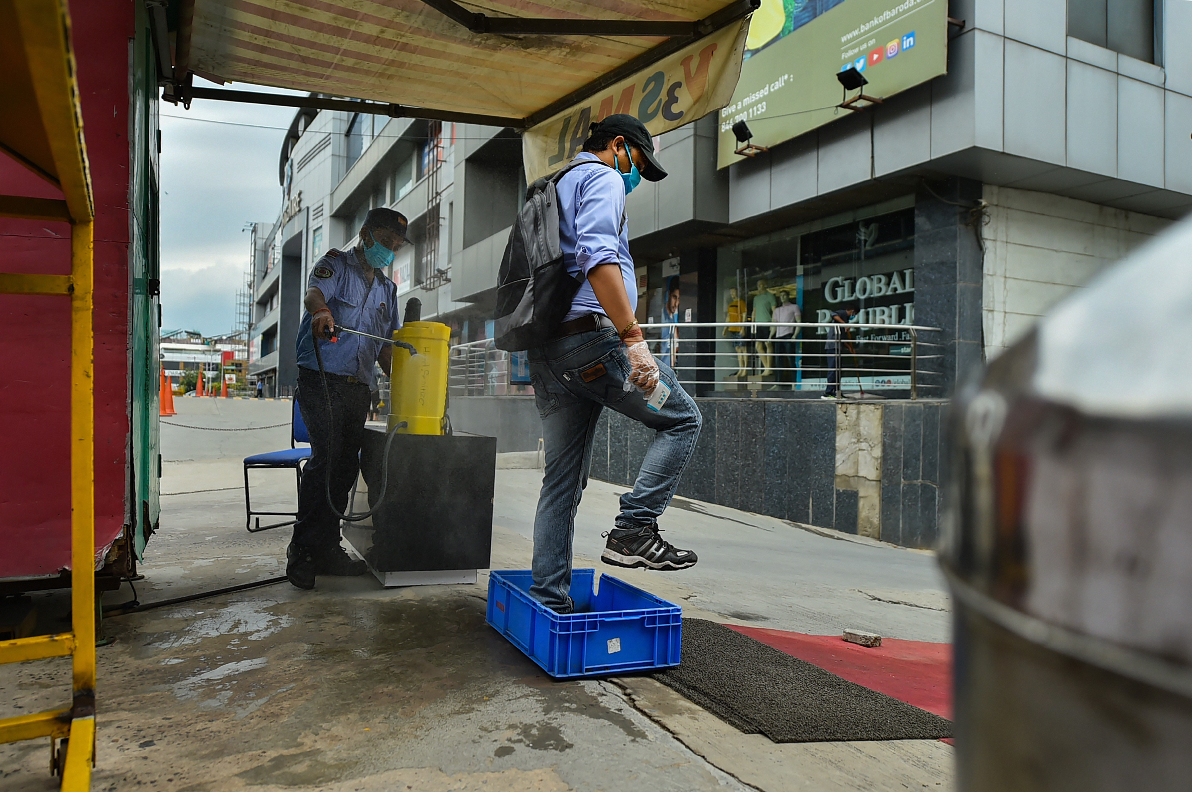 Workers carry out cleaning work at the V3S mall as it prepares to re-open amid ongoing Covid-19 lockdown, in east Delhi, Sunday, June 7, 2020.