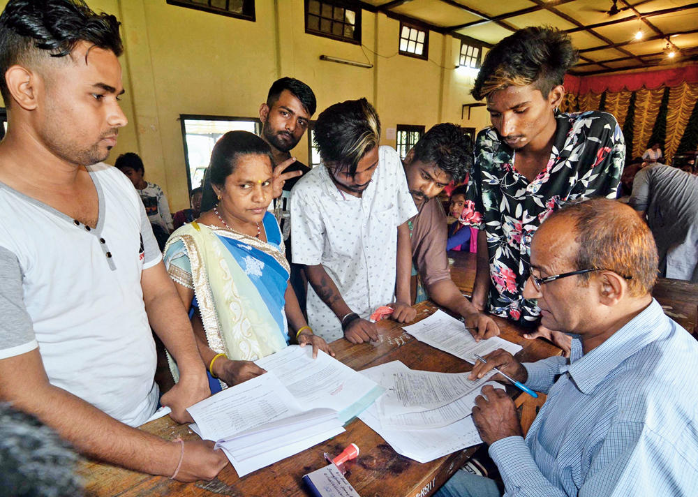 Applicants get their documents verified at an NRC Seva Kendra in Guwahati