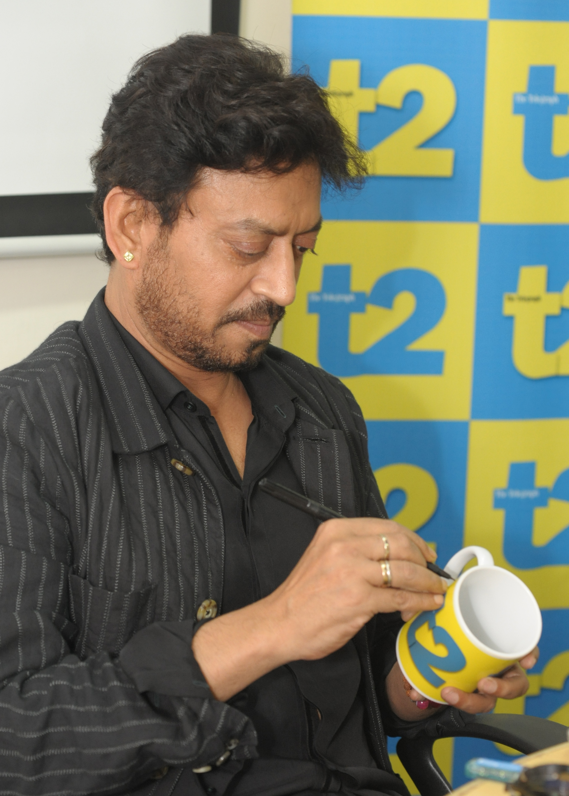 Irrfan Khan signing a t2 mug