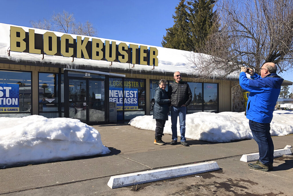 Bend resident Debby Saltzman poses for a photo in front of the last Blockbuster store on the planet with her twin brother, Michael Trovato.
