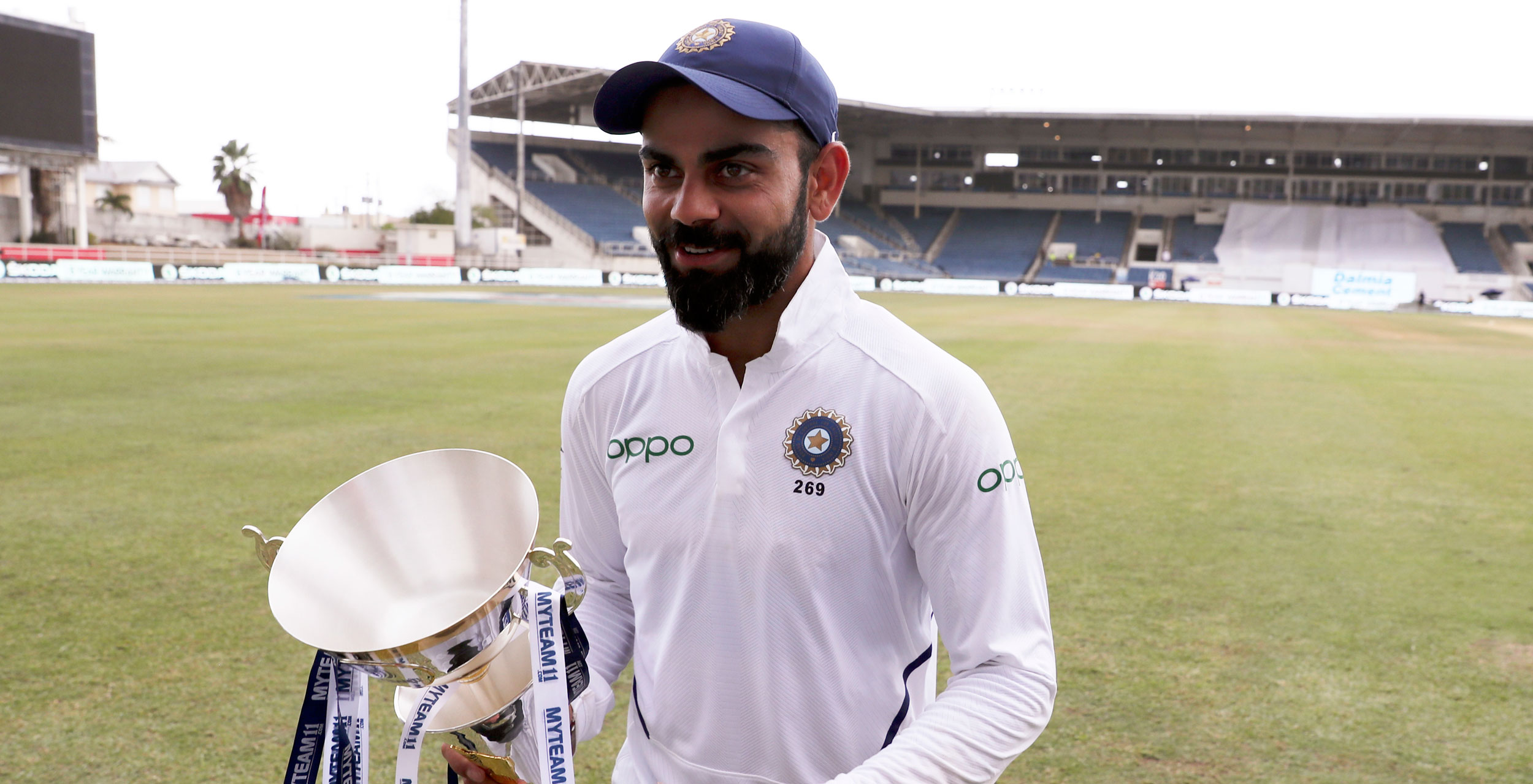 Virat Kohli walks with the series trophy after day four of the second Test cricket match against West Indies at Sabina Park cricket ground in Kingston, Jamaica, September 2, 2019. 