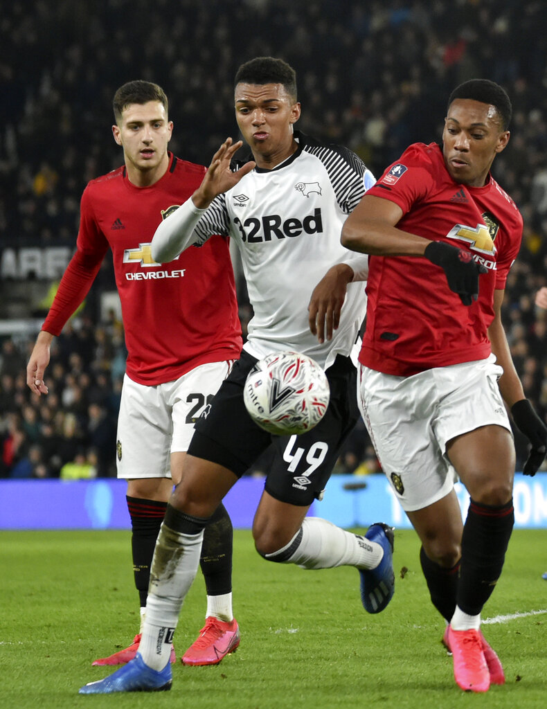 Anthony Martial (right) duels for the ball with Derby's Morgan Whittaker during the FA Cup fifth round football match between Derby County and Manchester United in Derby on Thursday