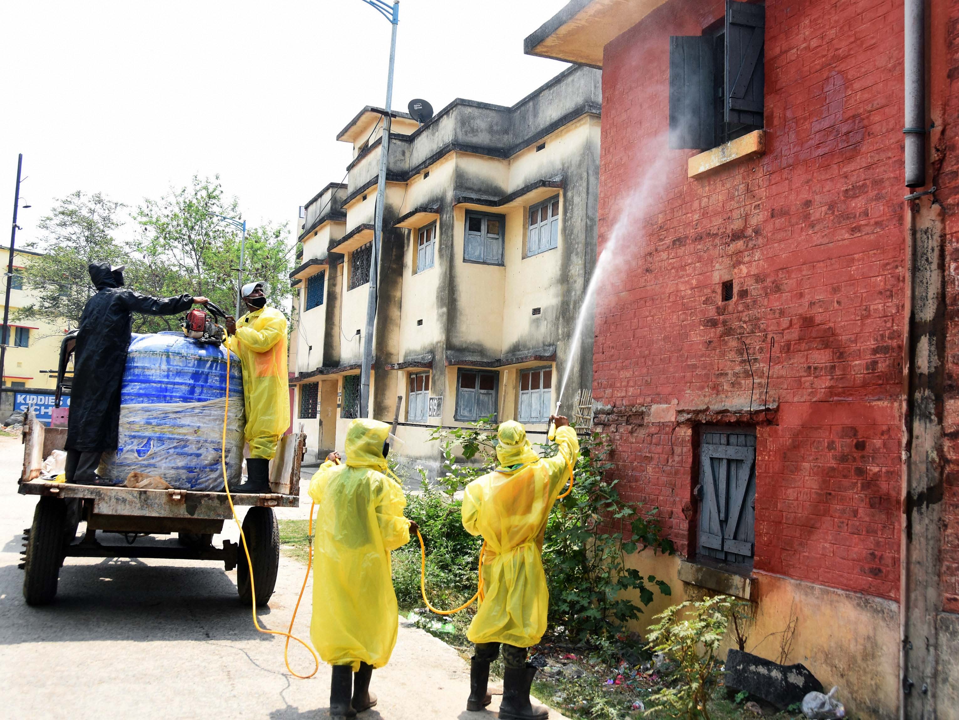 Municipal Corporation workers sanitize DS Colony where a man was found positive with Covid-19 during a nationwide lockdown in the wake of coronavirus pandemic, in Dhanbad, Sunday, April 19, 2020