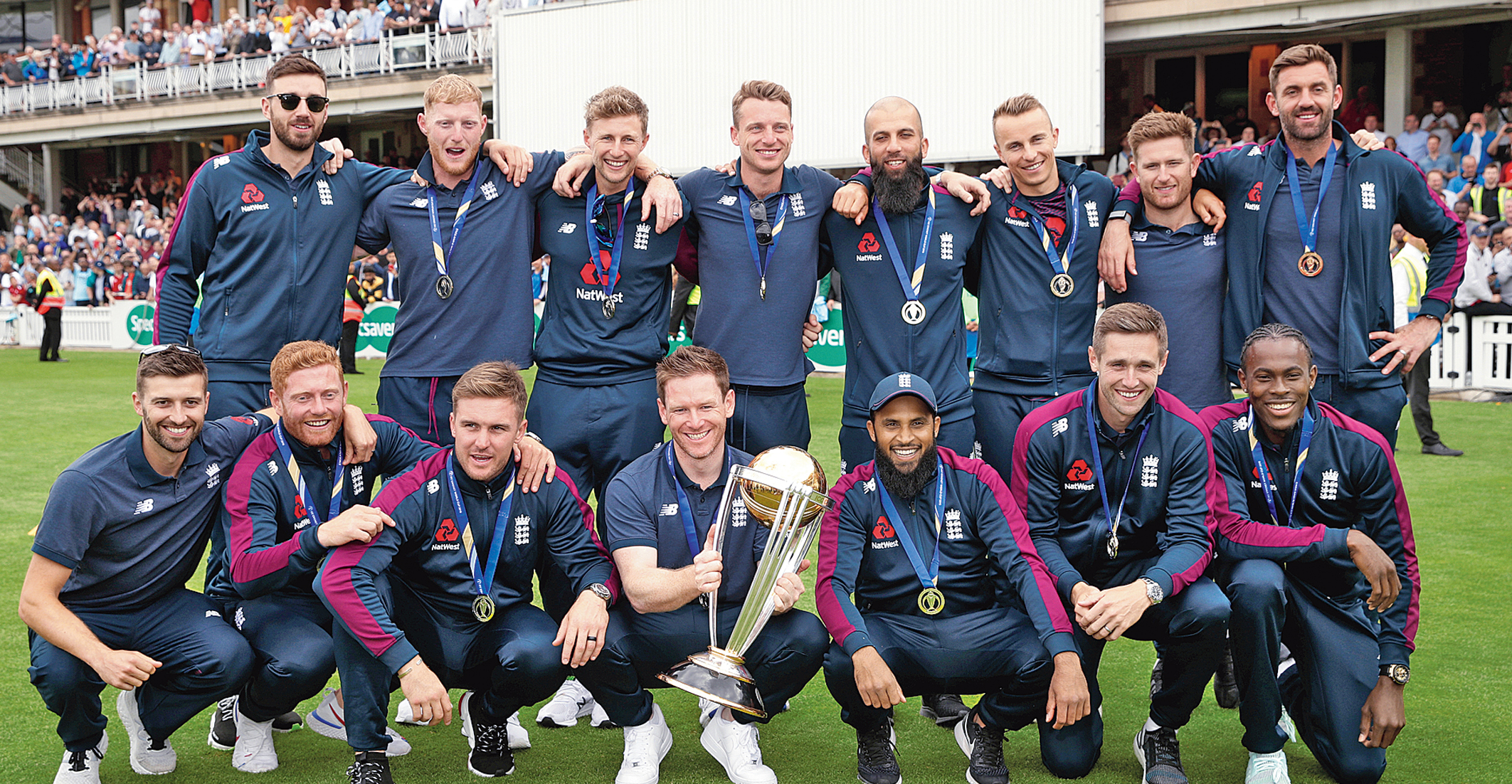 The victorious England players pose with the World Cup trophy at The Oval on Monday. England defeated New Zealand in the final on Sunday. 