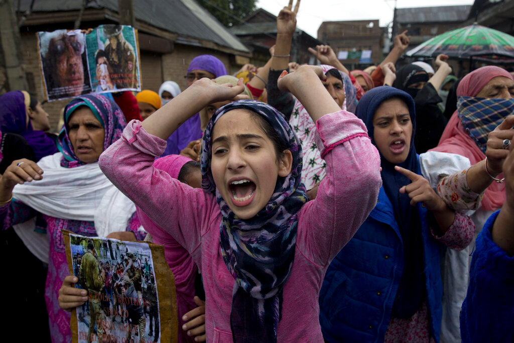 Kashmiris shout slogans during a protest after prayers against the abrogation of Article 370 on the outskirts of Srinagar on Friday