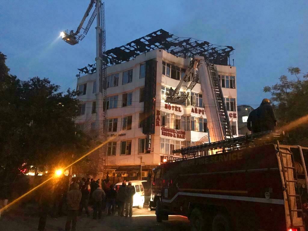 In this photo provided by Sivanand Chand, a hotel guest who was rescued, firefighters at work at Arpit Palace Hotel.