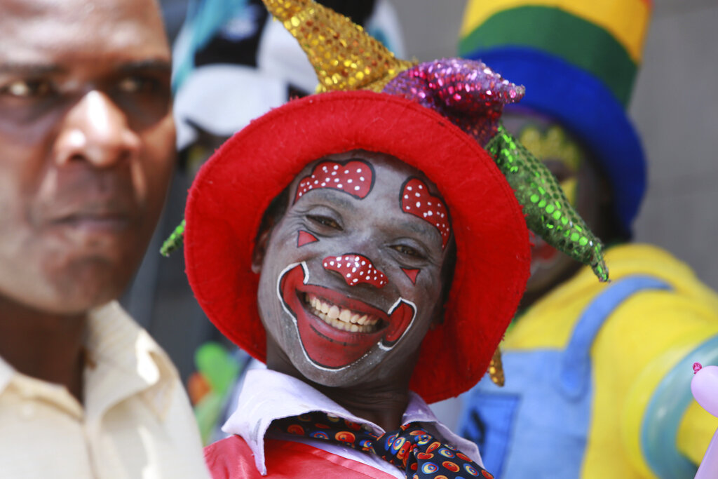 A clown is seen on the streets of Harare in this Saturday, Dec. 21, 2019, photo. Zimbabwe faces Christmas amid a harsh economic crisis that has forced many people to queue for cash and for fuel, making it difficult to plan for the festive period.