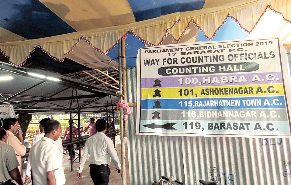 Officials walk into the counting centre at Barasat College on May 23. 