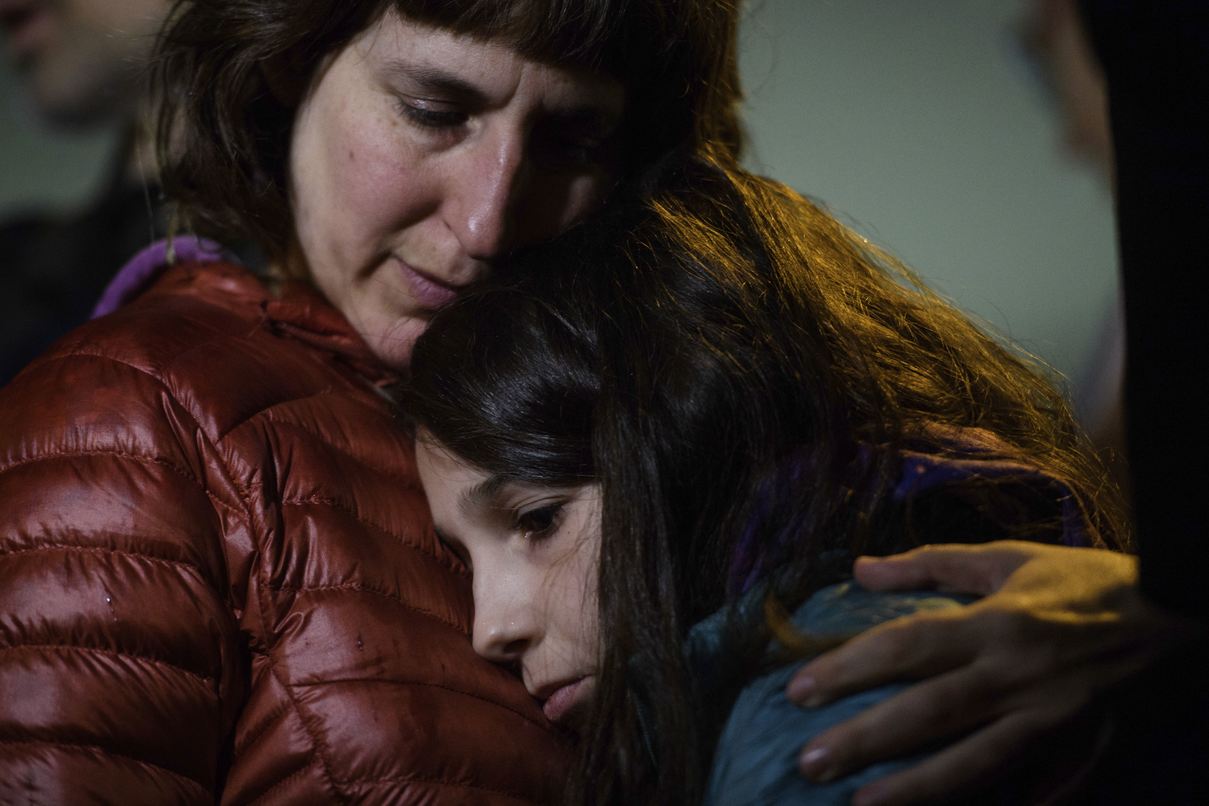 Rachel Kranson (left) holds her daughter, Sasha Kranson, 12, during a vigil after an active shooter fatally shot multiple people at Tree of Life Congregation synagogue on October 27 in their neighborhood of Squirrel Hill in Pittsburgh.