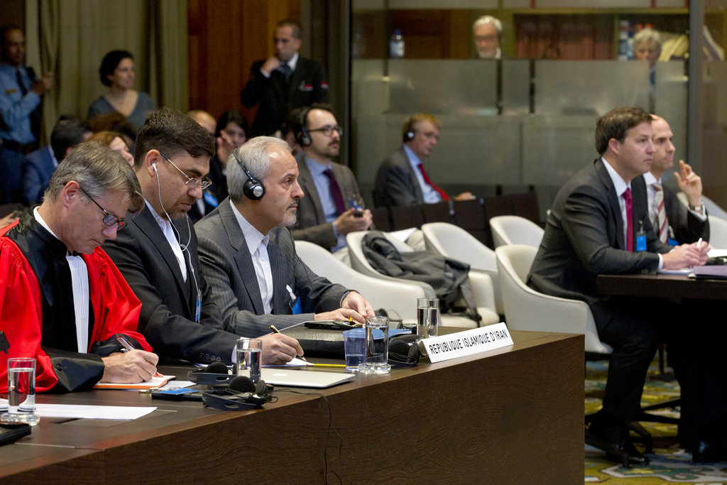 Mohammed Zahedin Labbaf (third left), agent for the Islamic Republic of Iran, and the US delegation (right) listen to the ruling of the judges.