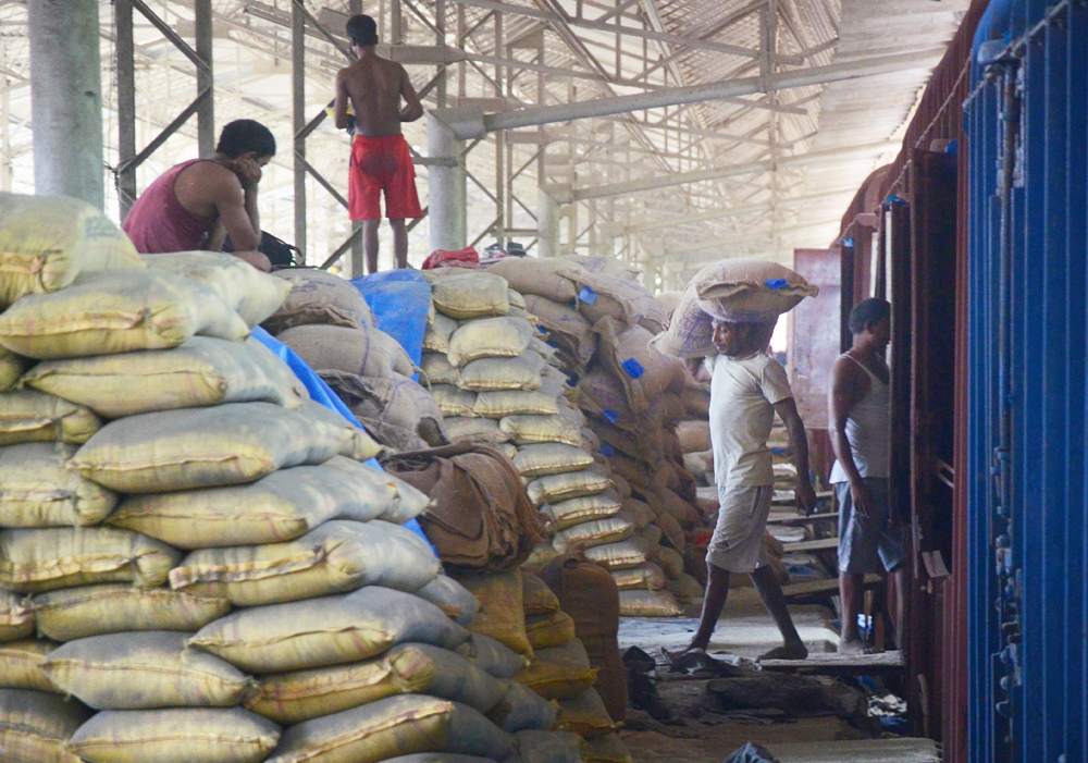 Labourers unload sacks of rice from goods train at Container Corporation of India Ltd yard during the ongoing Covid-19 lockdown, in Navi Mumbai, Wednesday, June 10, 2020. 