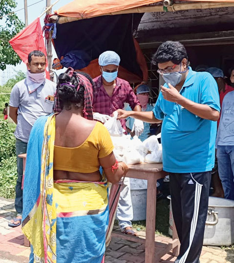 A FEED volunteer serves food