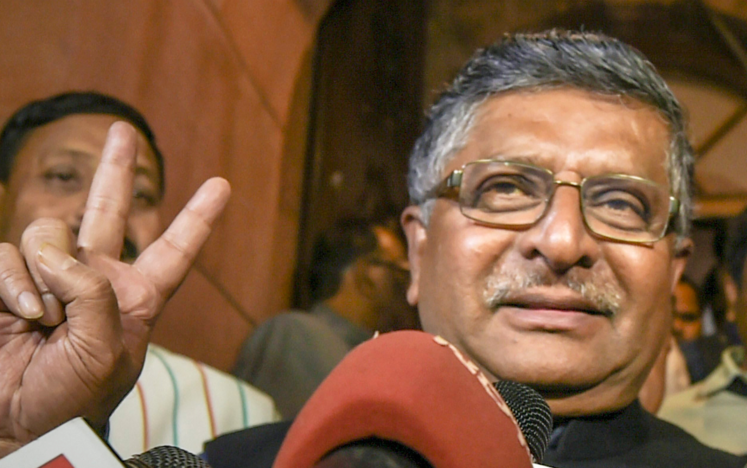 Union Law Minister Ravi Shankar Prasad flashes the victory sign as he comes out of the Parliament House after Triple Talaq bill was passed in Lok Sabha on Thursday. 