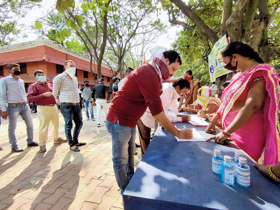 Public administration department distribute hand sanitizers at district collectorate in Ranchi on Tuesday. 