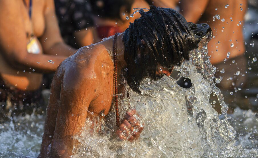 A man takes a dip in the Ganga at the Kumbh Mela in Allahabad.