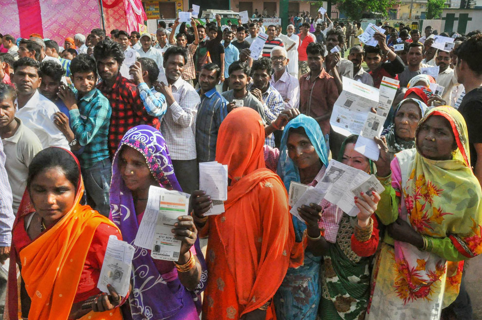 Voters wait in long queues to cast their votes at a polling station, during the third phase of Lok Sabha polls, in Moradabad, Tuesday, April 23, 2019.