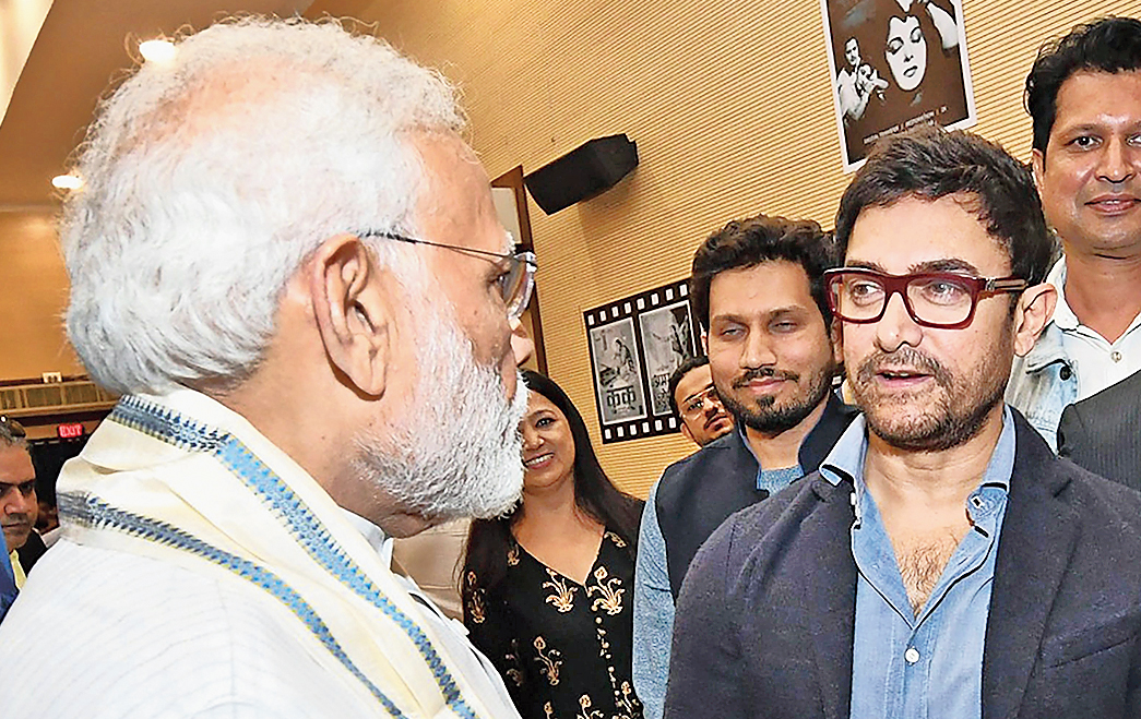 Modi interacts with actor Aamir Khan during the inauguration of the National Museum of Indian Cinema in Mumbai on Saturday.