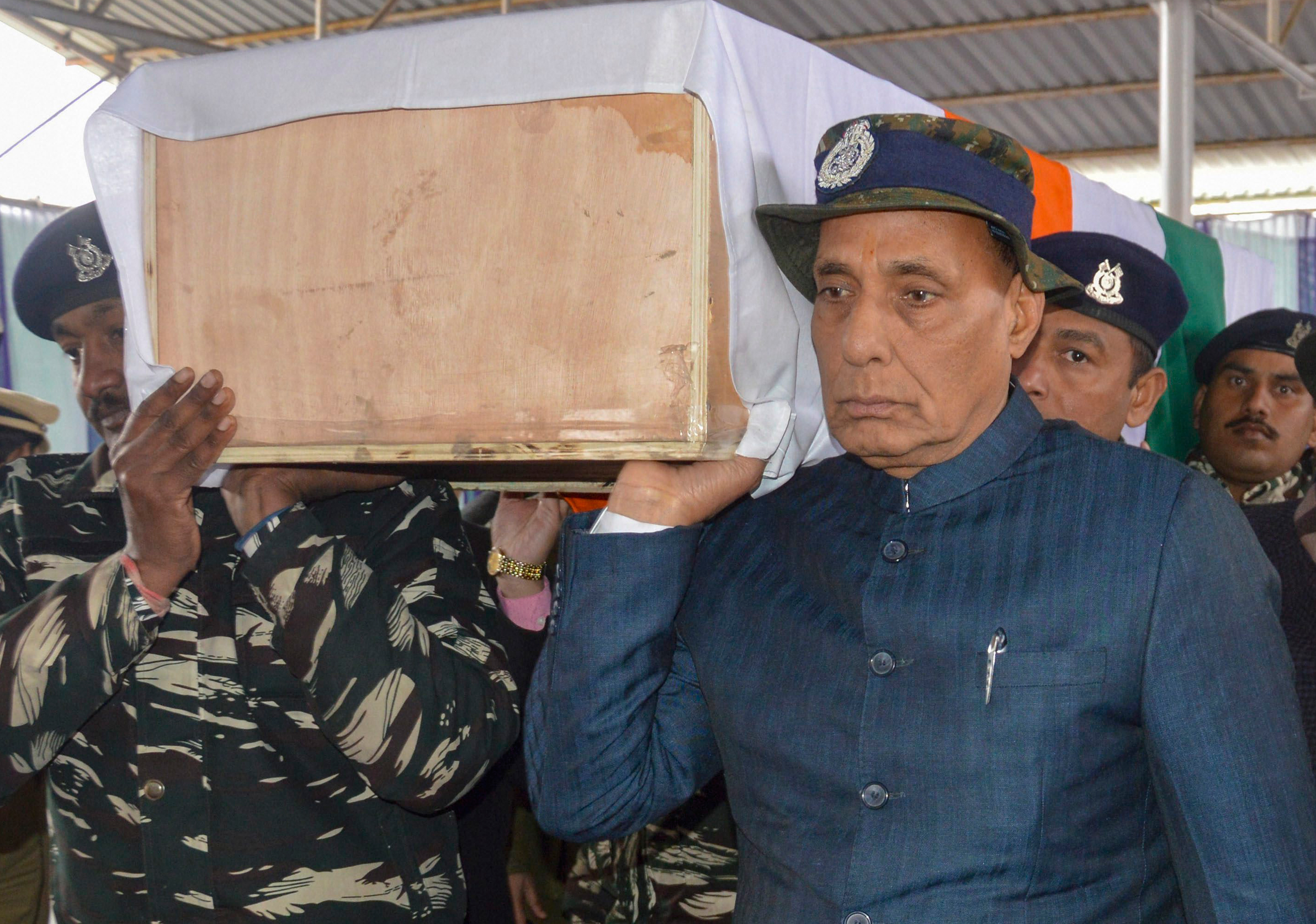 Rajnath Singh carries the coffin of a slain CRPF jawan during a wreath laying ceremony at the CRPF camp in Budgam on Friday.
