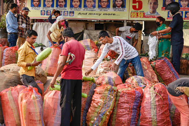 Locals buy vegetables, supplied by Assam Food Supply Department, during a nationwide lockdown, imposed in the wake of coronavirus pandemic in Guwahati 
