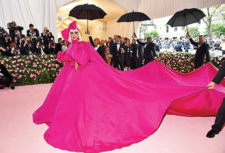 7.
Lady Gaga: Out of all her red carpet outings, which are nothing but memorable, her “performance” at the Met Gala last year, during which she tirelessly transitioned between four dramatic Brandon Maxwell looks — a fuchsia cape-gown with a
25-feet train, a strapless black number with exaggerated hips, a hot-pink cocktail dress and lastly, black lingerie with her signature chunky heels, was stuff that has quickly transcended to Met Gala history.