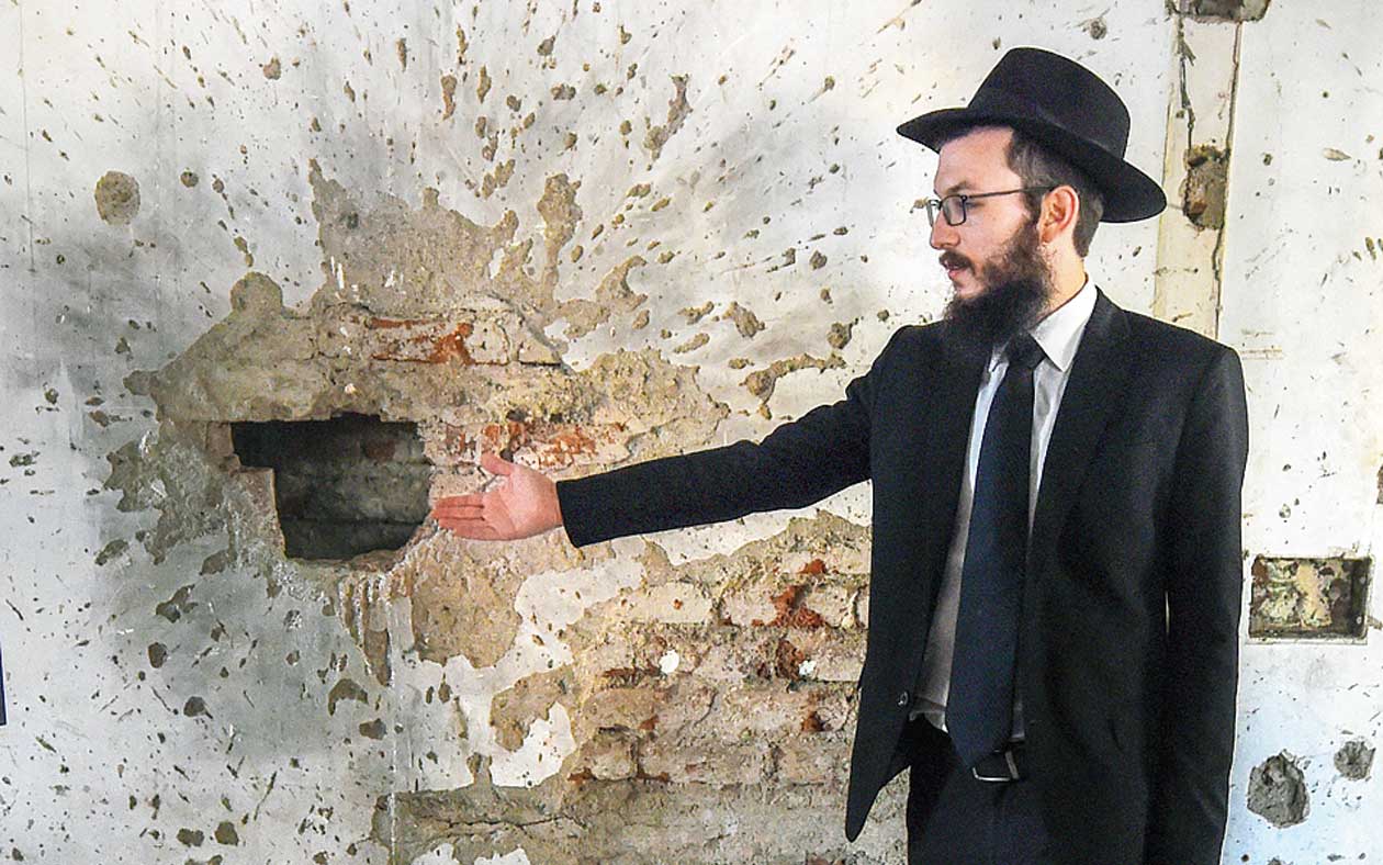 Rabbi Israel Kozlovsky points to bullet marks at Nariman House on Sunday, the eve of the 10th anniversary of the 26/11 attacks. 