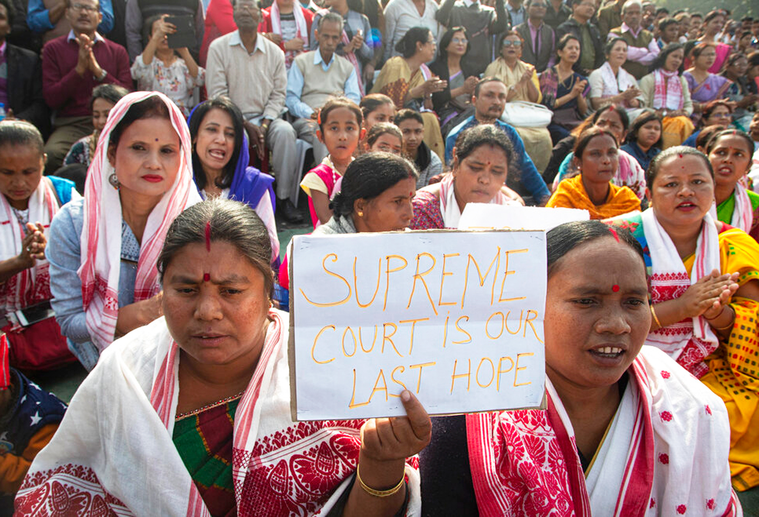 A woman holds a placard during a protest against the Citizenship Act in Guwahati.