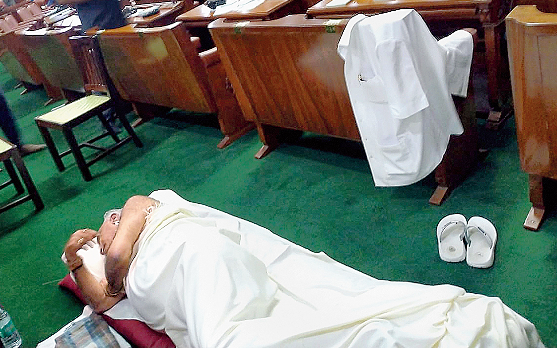 The BJP’s Karnataka unit chief, BS Yeddyurappa, asleep on the floor inside the Vidhana Soudha in Bangalore on Thursday night, his shirt hanging from a chair in the Assembly and his slippers kept neatly by the side. 
