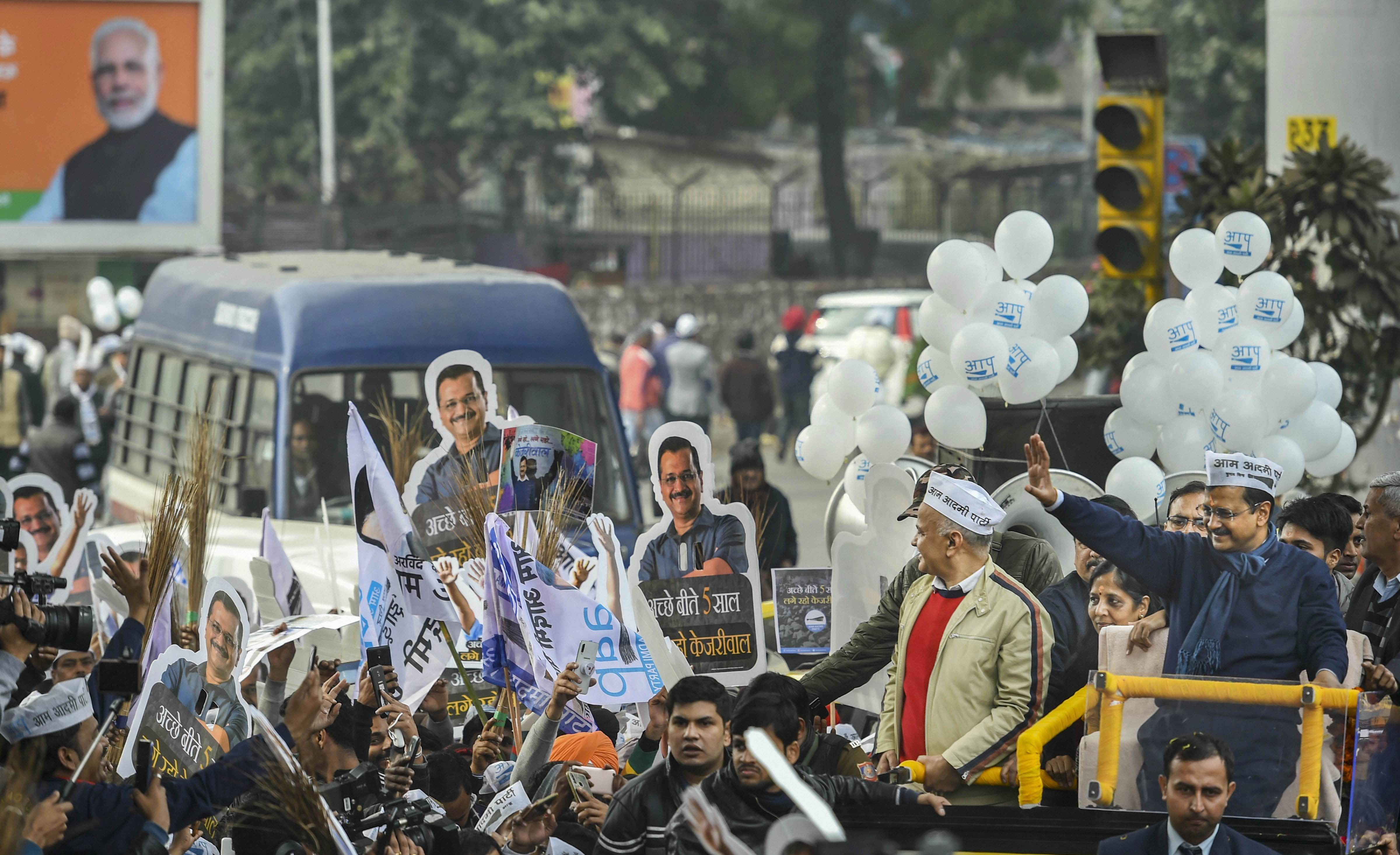 AAP convener and Delhi chief minister Arvind Kejriwal waves from an open vehicle during a roadshow, in New Delhi, Monday, January 20, 2020.
