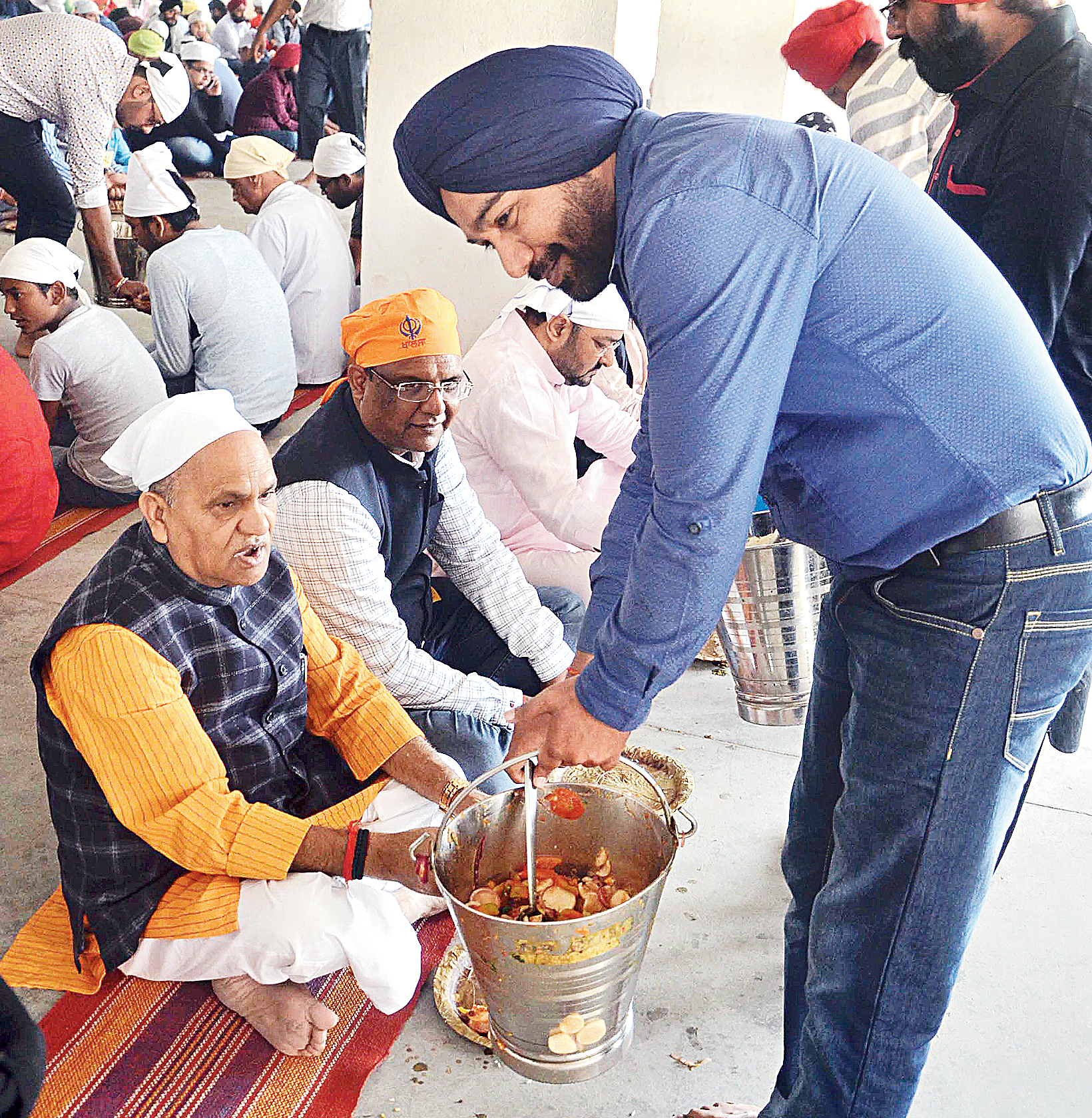 State urban development minister CP Singh enjoys a meal at Guru Nanak school in Ranchi on Friday