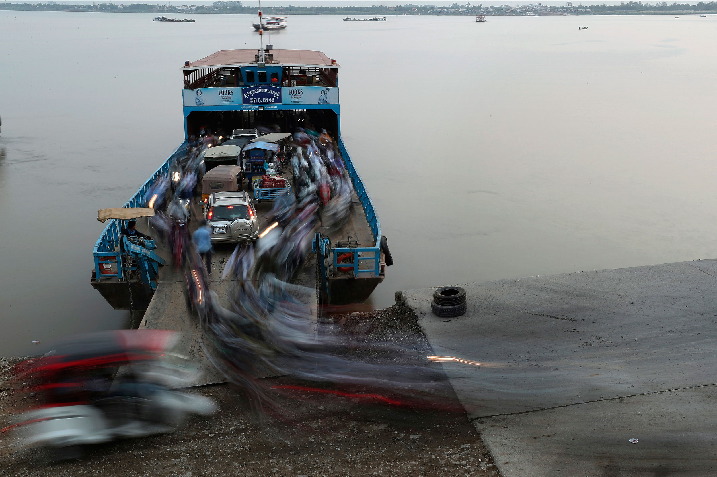 Passengers get off from a ferry after crossing the Mekong river from Arey Ksat to Phnom Penh, Cambodia, on Tuesday.