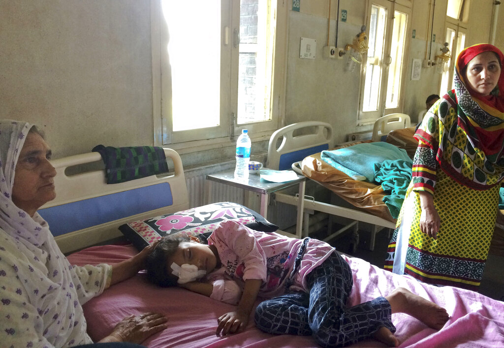 Grandmother Sara Ali, left, attends to six-year-old Muneefa Nazir, at a hospital after the girl was wounded by a marble shot from a sling used by Indian paramilitary soldiers in Srinagar, on Tuesday, August 13, 2019