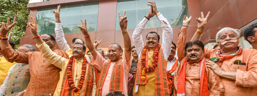 Uttar Pradesh Chief Minister Yogi Adityanath and others celebrate the party's performance in Lok Sabha elections, at BJP office in Lucknow on Thursday, May 23, 2019. 