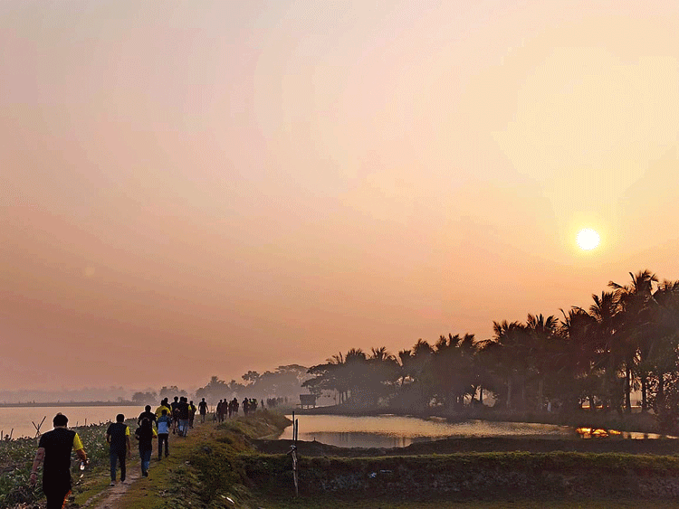 Participants of the trail run pass through the East Calcutta Wetlands on Sunday. 
