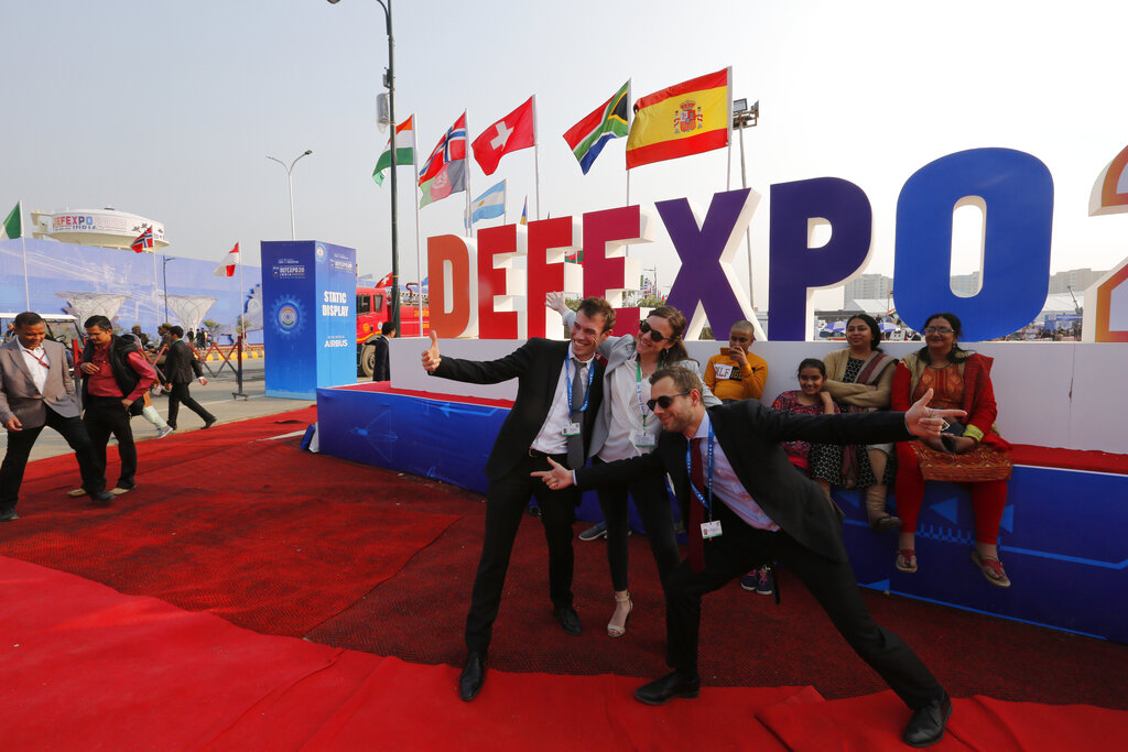 Delegates from France take a photograph at the DefExpo in Lucknow, India, on Thursday