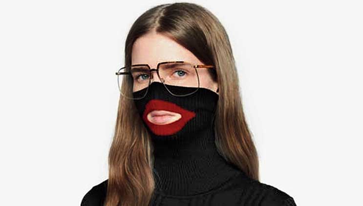 A screenshot from an online fashion outlet shows the black Gucci balaclava sweater that the company apologised for and dropped. 