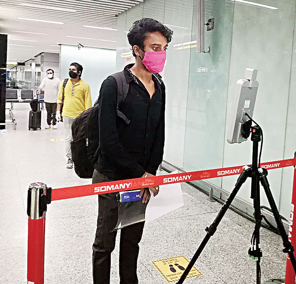 A camera checks a flier’s temperature at Calcutta airport
