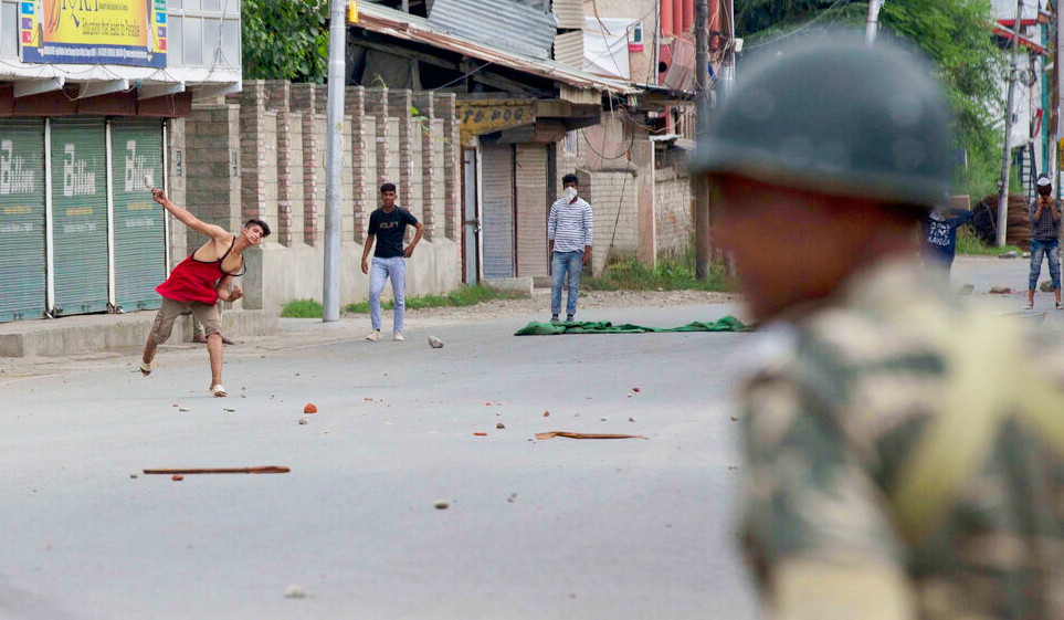 Kashmiri protesters throw stones at Indian paramilitary soldiers during curfew like restrictions in Srinagar, Friday, August 16, 2019.