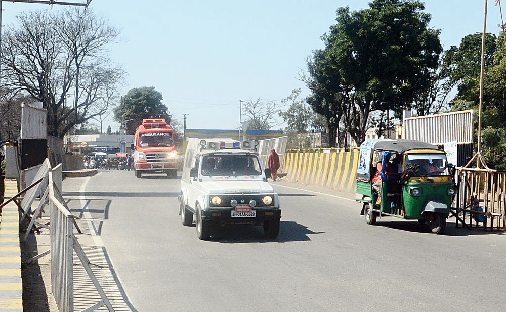 A police vehicle escorts the ambulance on the green corridor near Birsa Chowk in Ranchi on Monday. 
